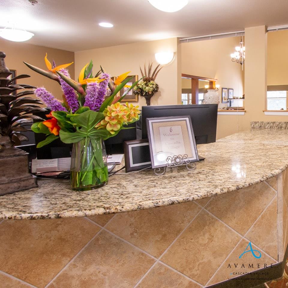A reception desk adorned with a vase of colorful flowers in an office lobby.