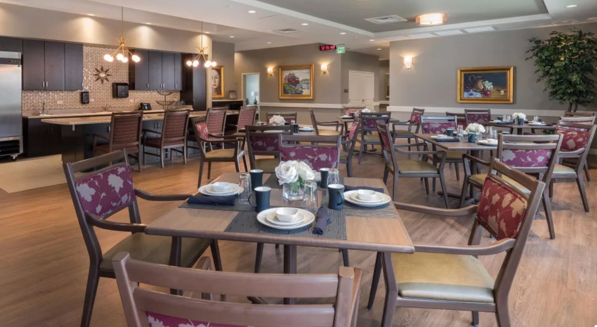 A well-arranged dining room with neatly set tables and chairs, creating an inviting atmosphere.