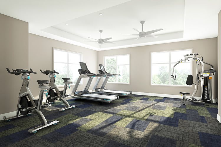 A modern, well-lit gym with treadmills and a stationary bike.