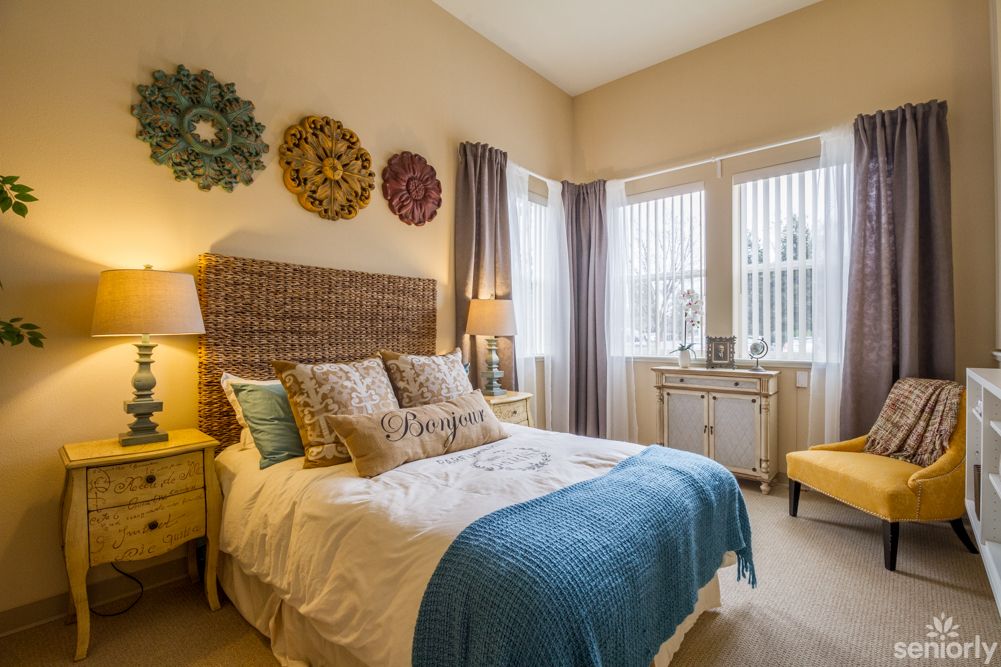 A cozy and modern bedroom featuring elegant decor, warm lighting, and stylish furnishings.