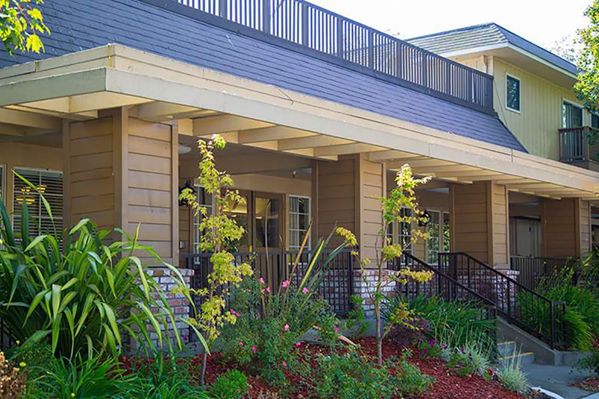 A modern building exterior with landscaped gardens.