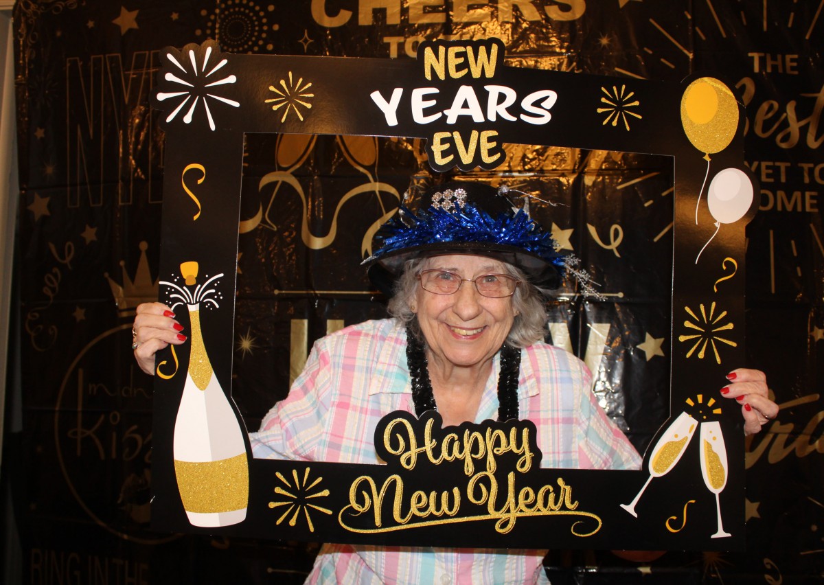 A joyful celebration of New Year's Eve with festive decorations and a photo frame.