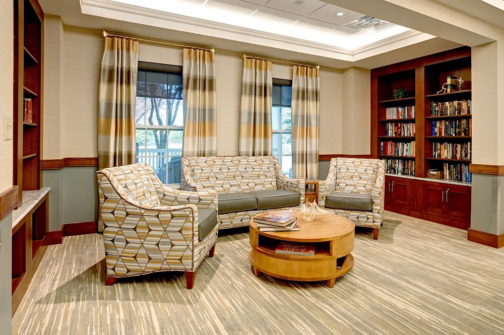 A cozy living room with patterned furniture and a wooden coffee table.