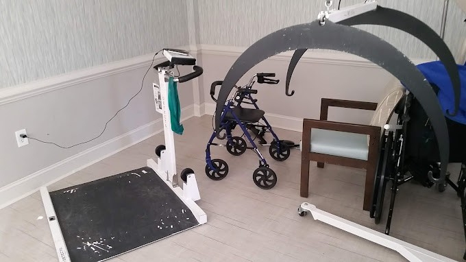 A healthcare setting featuring mobility and medical equipment, including a wheelchair lift and a walker.