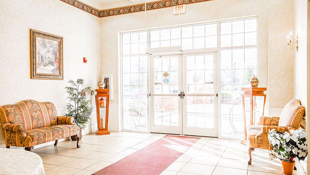 Brightly lit lobby entrance with glass doors and decorative elements.