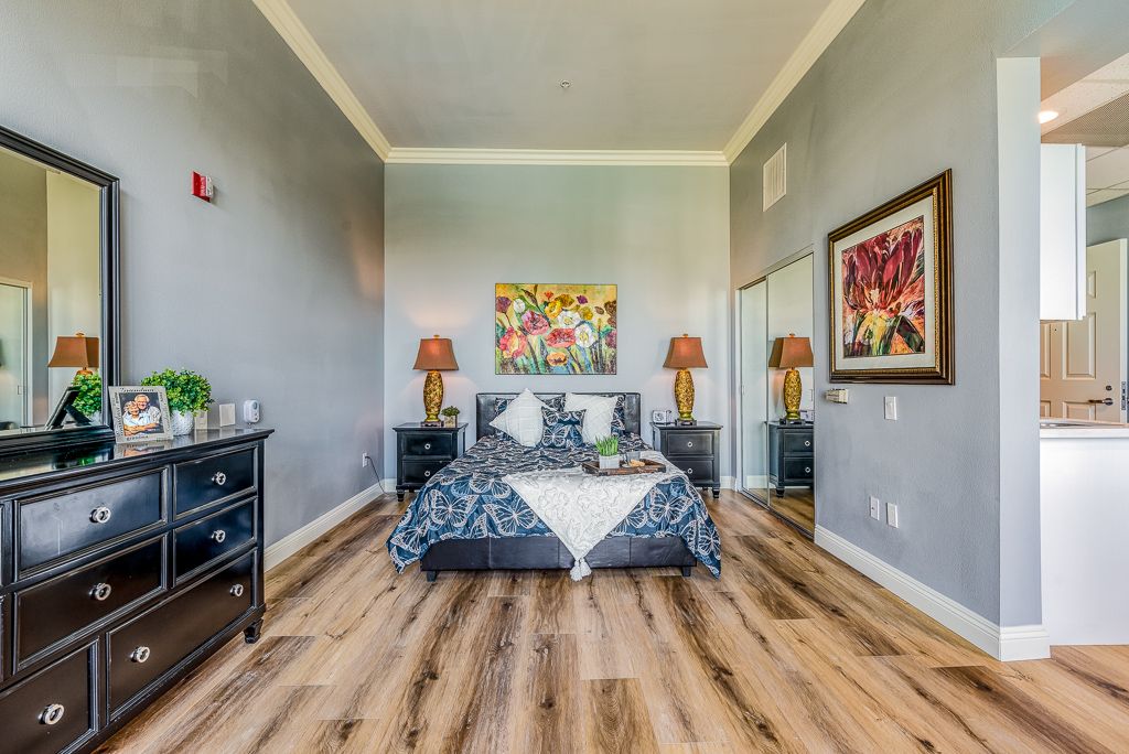 A stylishly decorated bedroom featuring modern furniture and vibrant artwork.