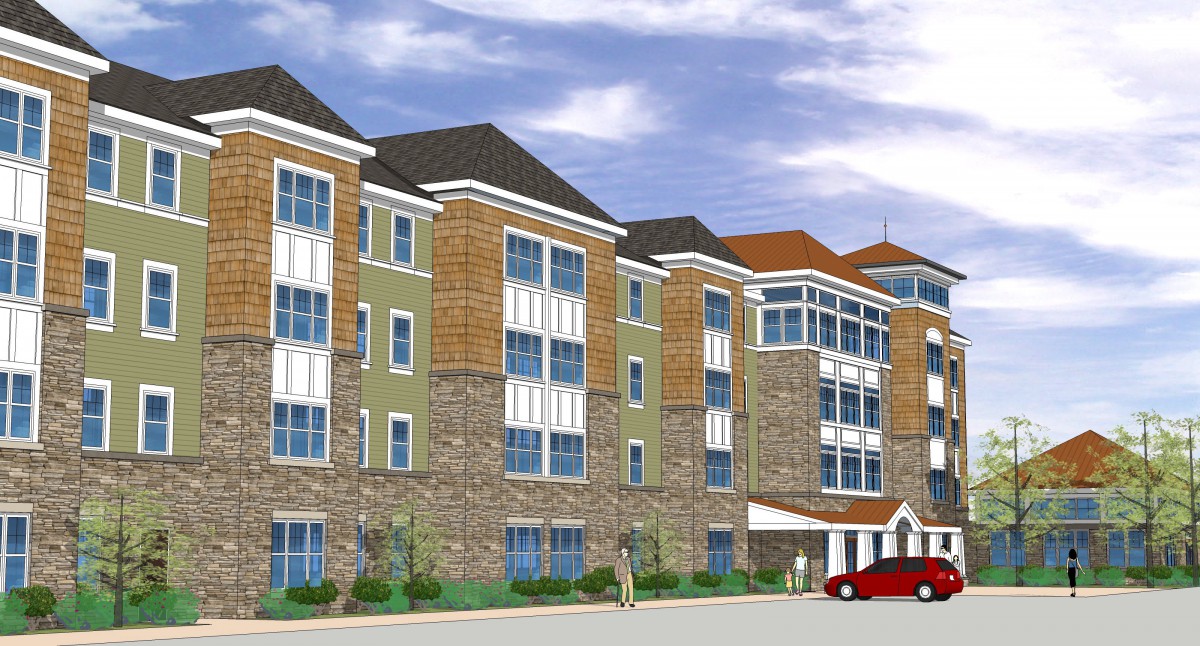 A modern multi-story apartment complex with a combination of stone and siding exterior.