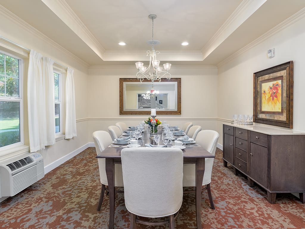 A well-appointed dining room with a chandelier and elegant table setting.