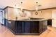 A modern indoor bar with a sleek counter and elegant lighting.
