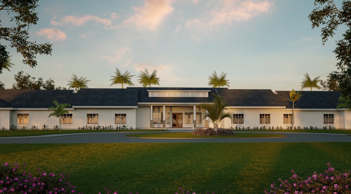 A modern house with palm trees in the sunset.