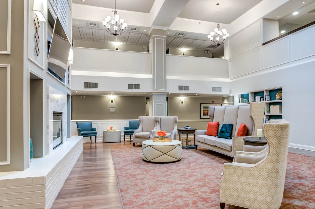A spacious modern lounge with comfortable seating and elegant decor.