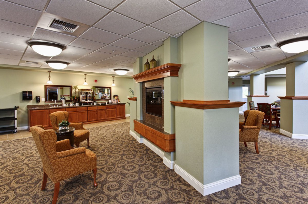 A comfortable lobby and reception area with seating and a fireplace.