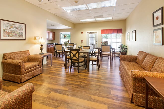 A cozy living and dining area with wooden flooring and comfortable furniture.