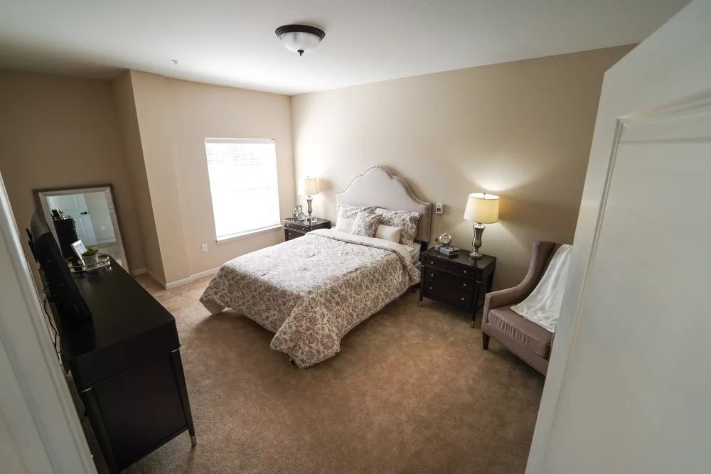 A cozy and well-furnished bedroom with a comfortable bed, nightstands, and lamps.