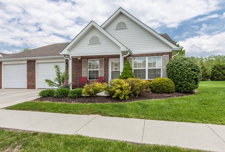 A suburban house with a nicely landscaped front yard.