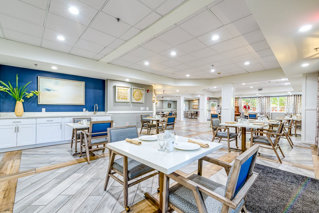 A spacious and modern dining area with neatly arranged tables and chairs.