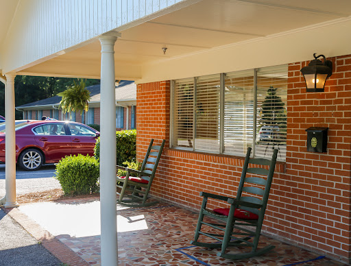 A cozy porch setup with rocking chairs inviting relaxation in a sunny residential area.