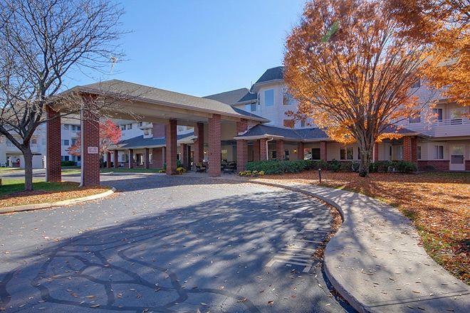 A picturesque view of a building entrance surrounded by autumn trees.
