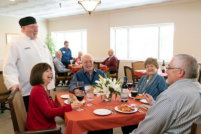 A group of seniors enjoying a meal together in a restaurant setting.