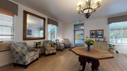 A welcoming lobby featuring elegant seating, a beautiful chandelier, and decorative elements.