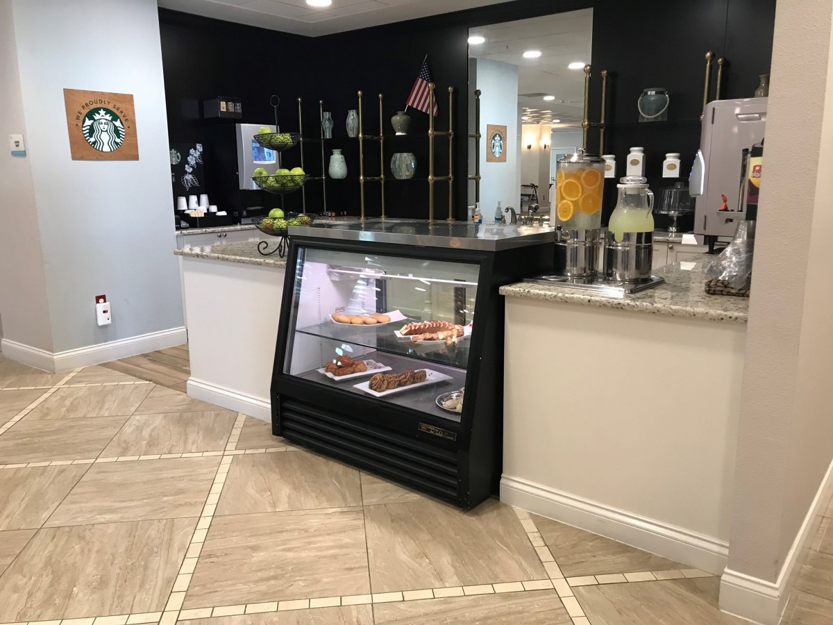 A modern bakery interior featuring a display case filled with various desserts.