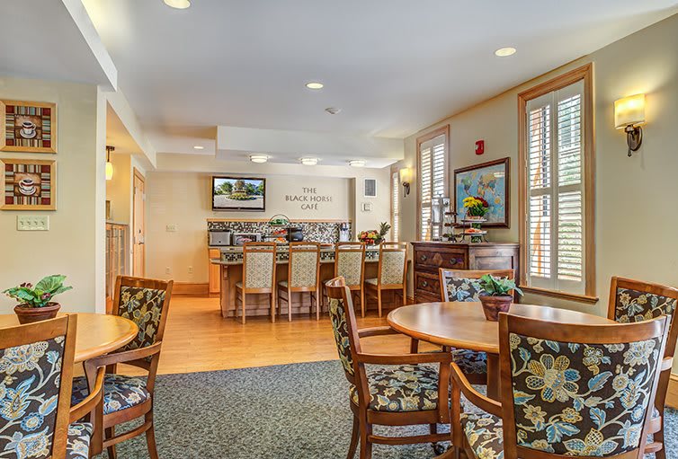 A cozy dining and bar area with modern furnishings and warm lighting.