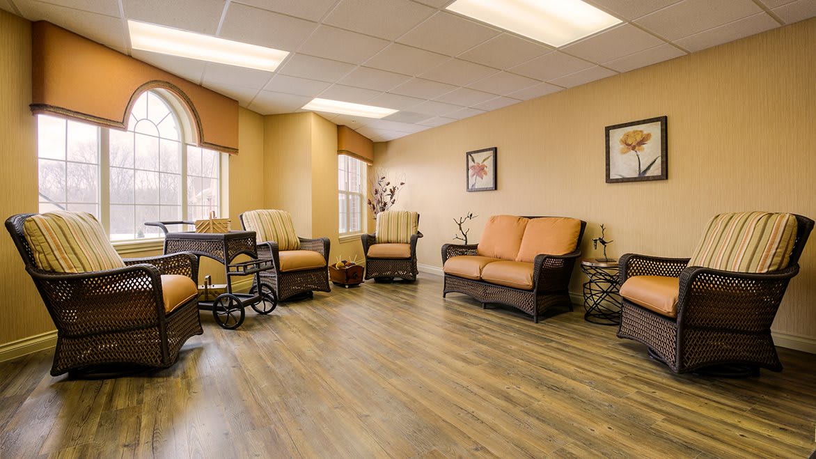 A cozy living room area with comfortable seating and ample natural light.