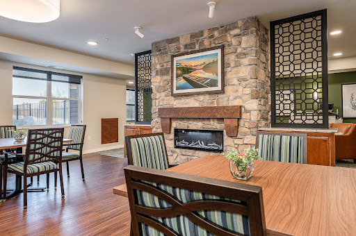 A cozy and modern living space featuring a stone fireplace and stylish dining area.