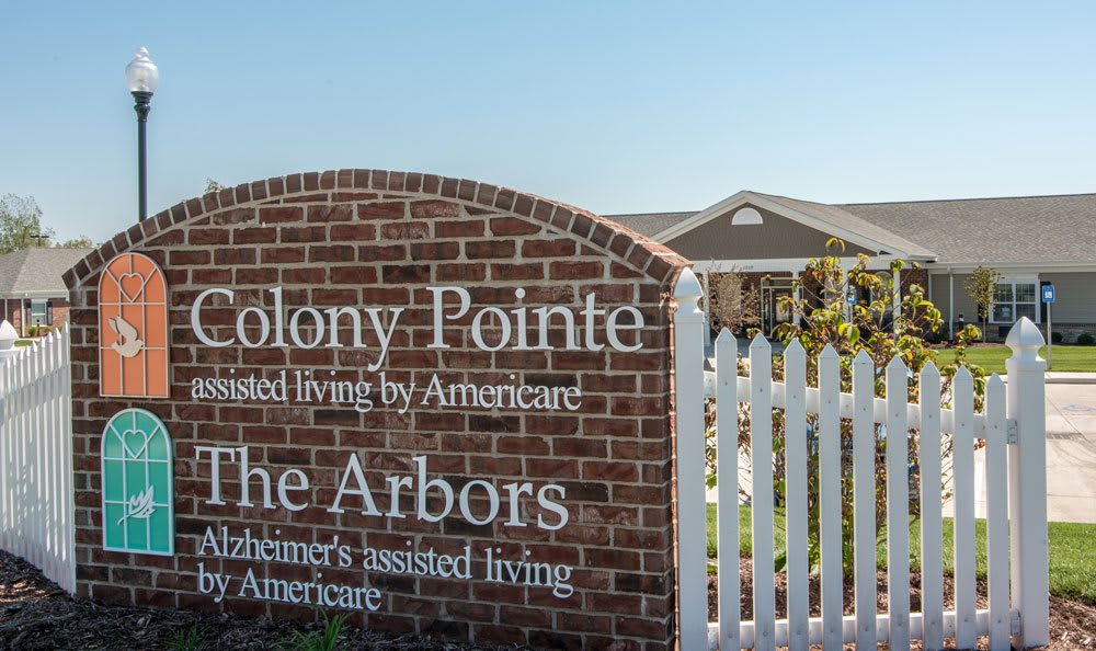 A brick sign for Colony Pointe and The Arbors, indicating an assisted living facility.