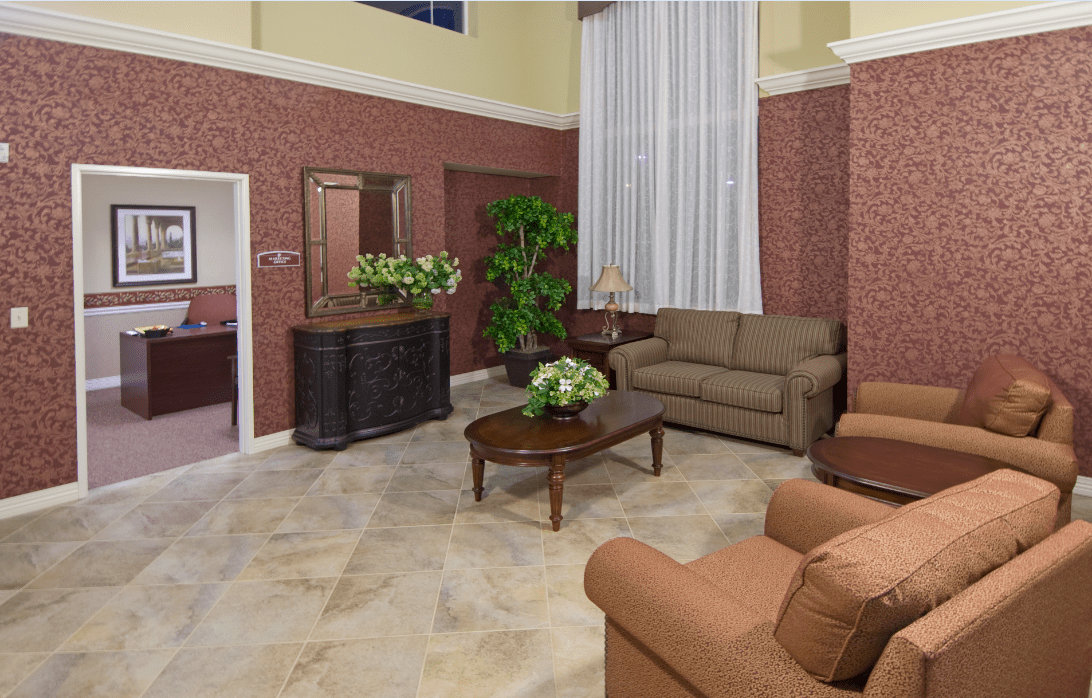 A cozy living room with elegant furniture and decorative plants.