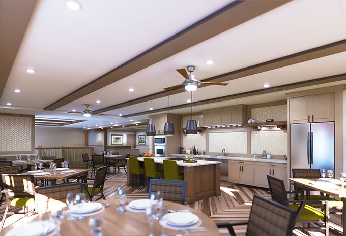 A spacious, modern kitchen with an open dining area, featuring sleek countertops and ceiling fans.