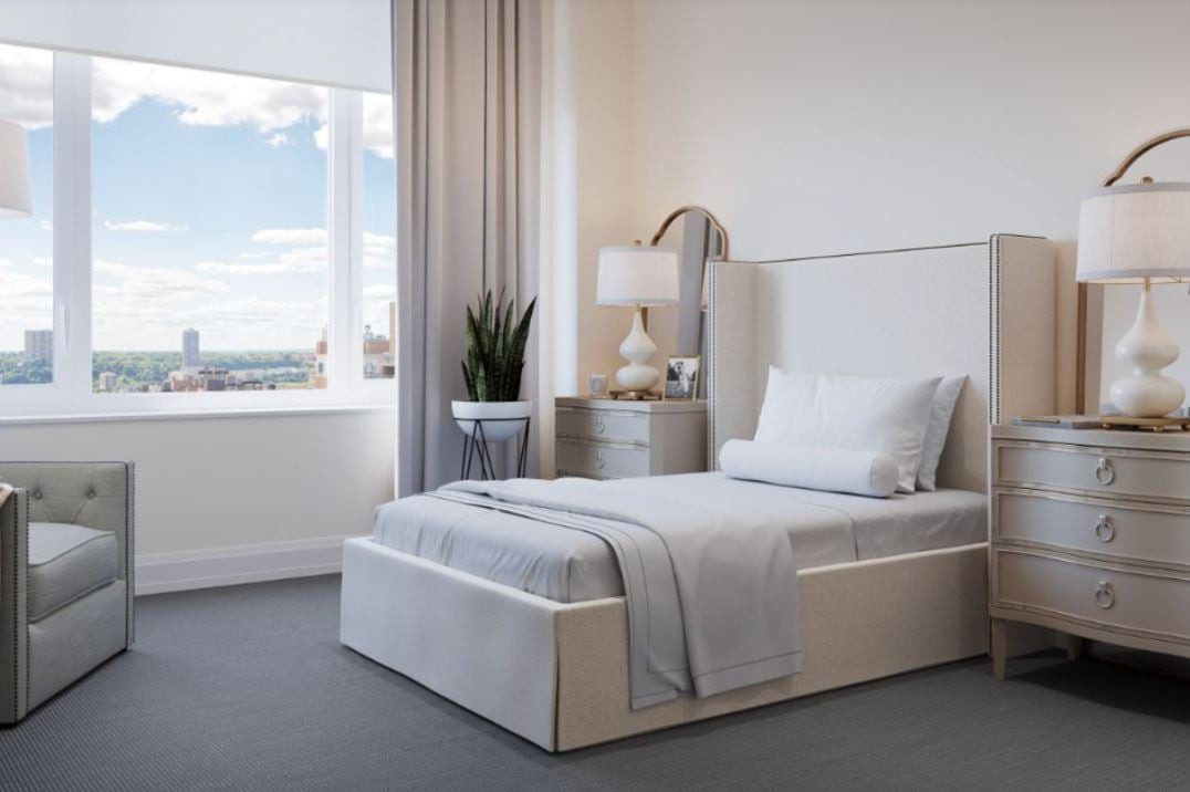 A modern, minimalist bedroom with a single bed and elegant decor.