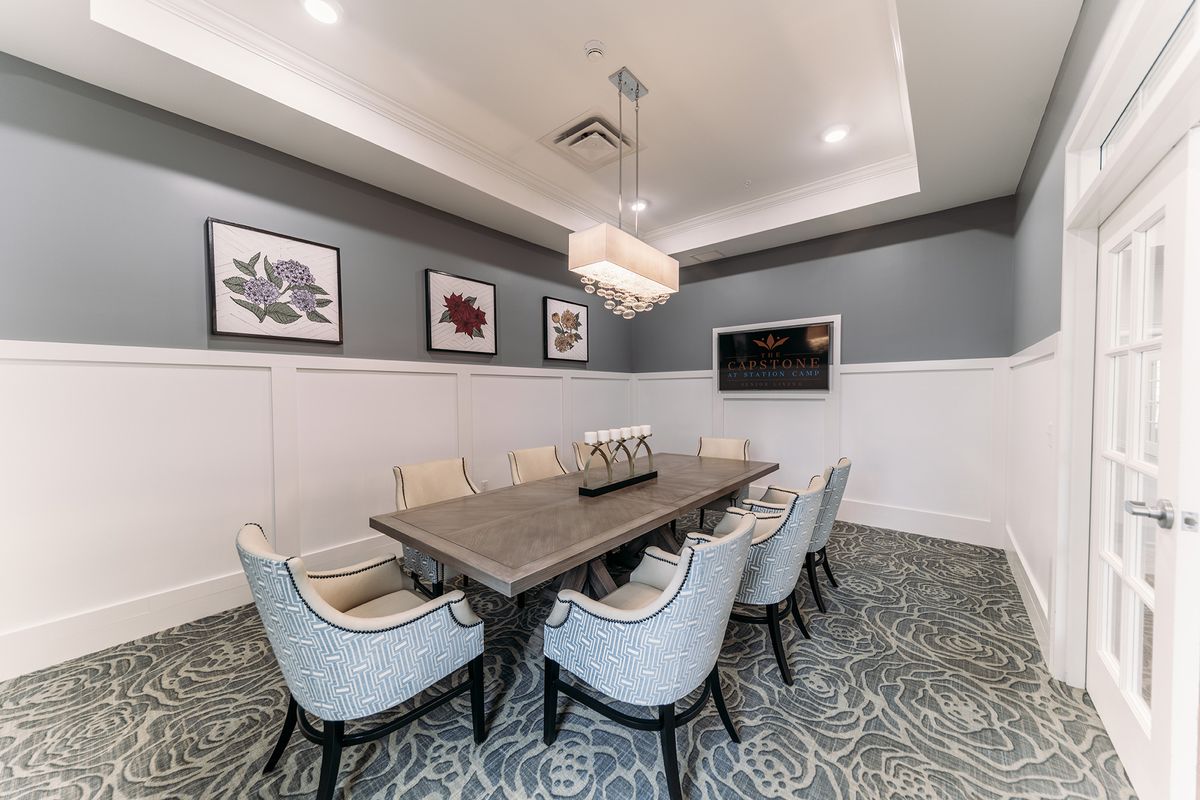 A modern conference room with a central table, elegant chairs, and stylish decor.