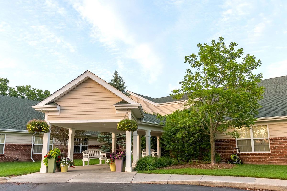 A welcoming residential home with a landscaped front yard and clear sky.