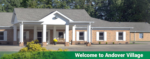 A welcoming entrance to a charming building surrounded by lush greenery.