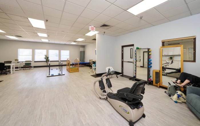 A spacious gym with exercise equipment and workout areas.