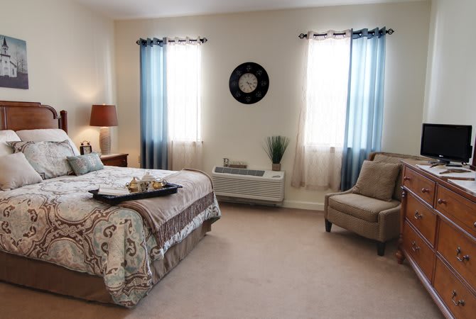 A cozy bedroom with stylish decor and natural light.