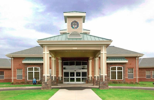 A modern architectural design featuring a clock tower and welcoming entrance.