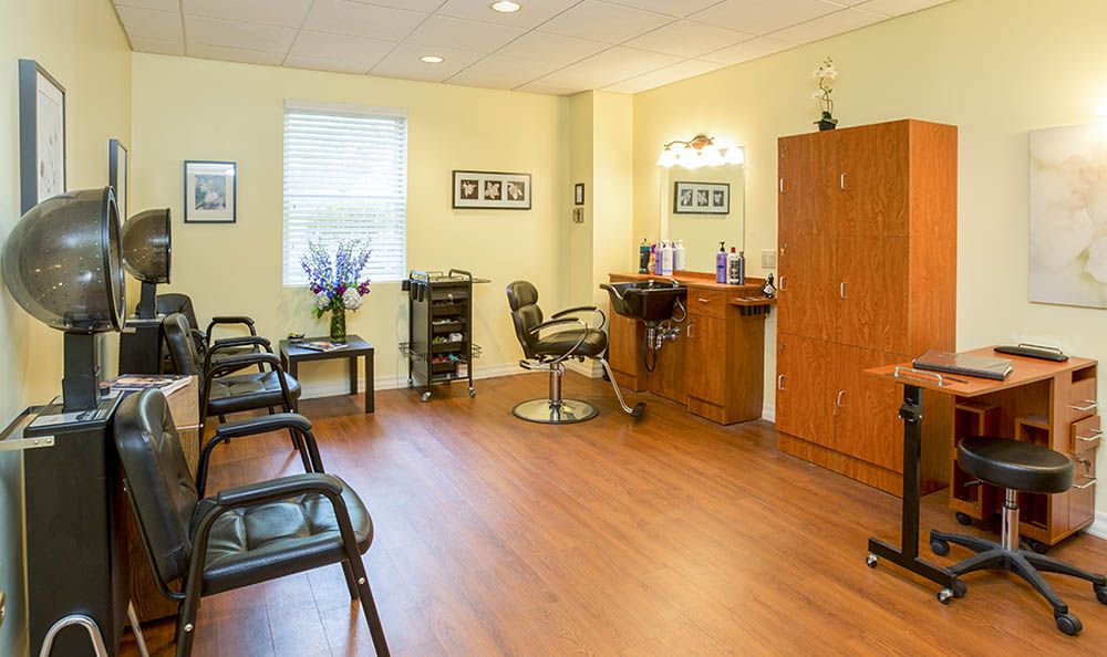 A modern hair salon interior with styling stations and chairs.