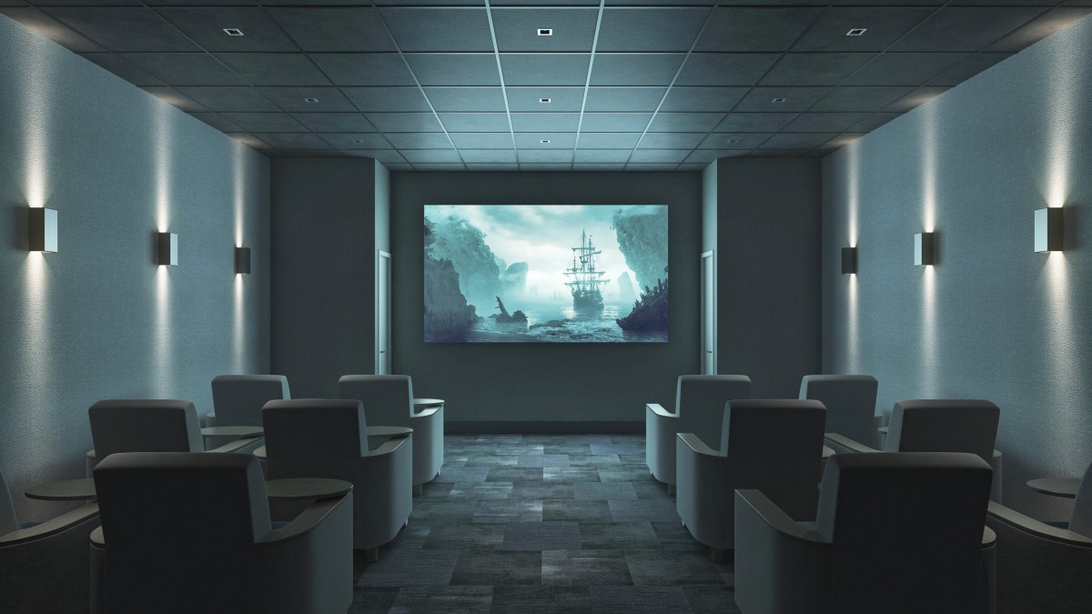 A cozy home theater setup with comfortable seating and a large projector screen displaying an adventurous scene.
