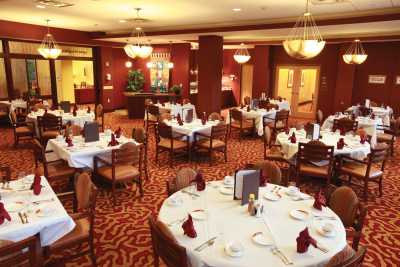 An elegant dining room with neatly set tables and chairs, ready for guests.