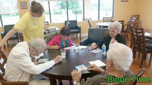 A group of seniors engaged in a game of bingo at a community center.