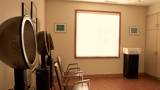 A serene waiting room with chairs and soft natural light filtering through the window.