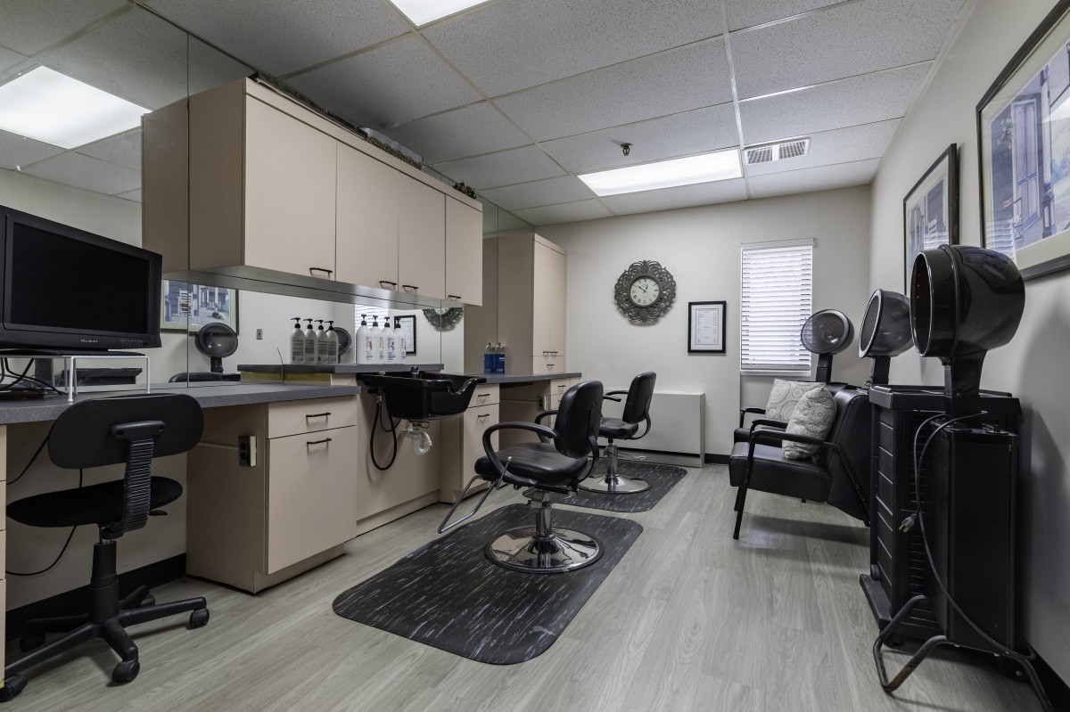 A modern hair salon interior with styling chairs and mirrors.