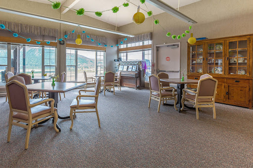 A bright and inviting recreation room with comfortable seating and large windows.