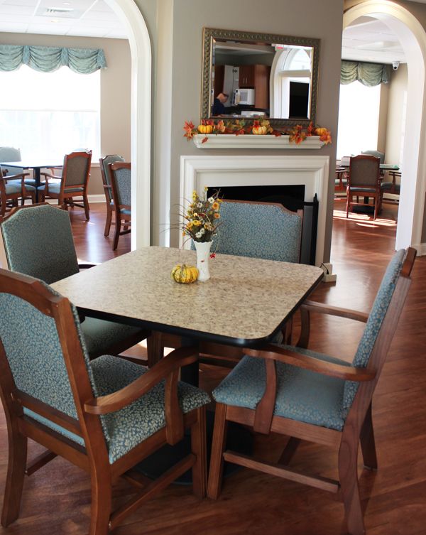 A cozy dining area with a table and chairs, featuring elegant decor.