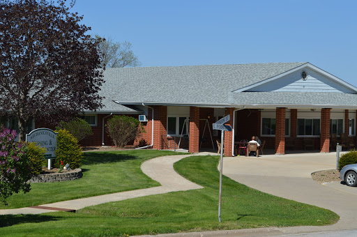A well-maintained residential building with a landscaped pathway and outdoor seating.