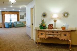 A cozy hallway leading to a living room with elegant furniture and decor.