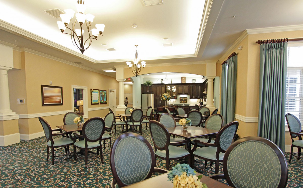 A well-lit dining area with neatly arranged tables and chairs.