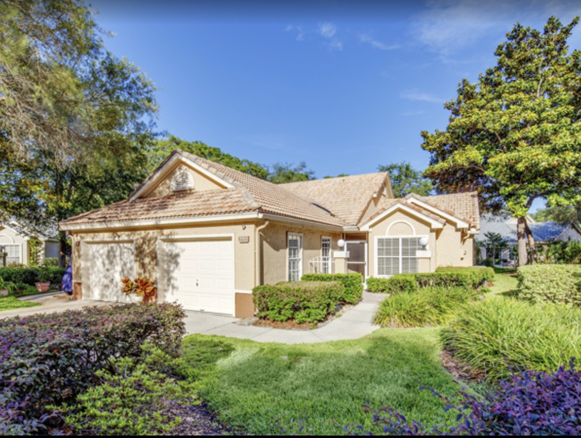 A suburban single-story house with well-maintained landscaping and a spacious driveway.